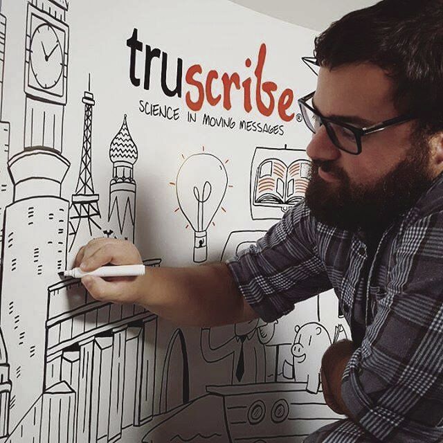 A TruScribe artist gets to work on a whiteboard.