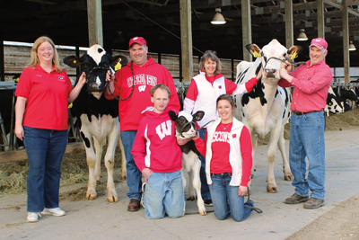 A family that farms together — (kneeling, front) Andrew and Kimberly Keller and (standing, from left) Kareen and Mark Keller and Sandy and Tim Keller with holsteins young and old.