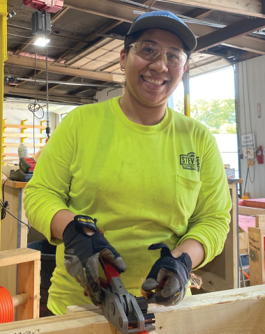 In a Cottage Grove wall fabrication plant, Karen Rangel attaches sheeting to a panel before it gets shipped out to a local construction site.