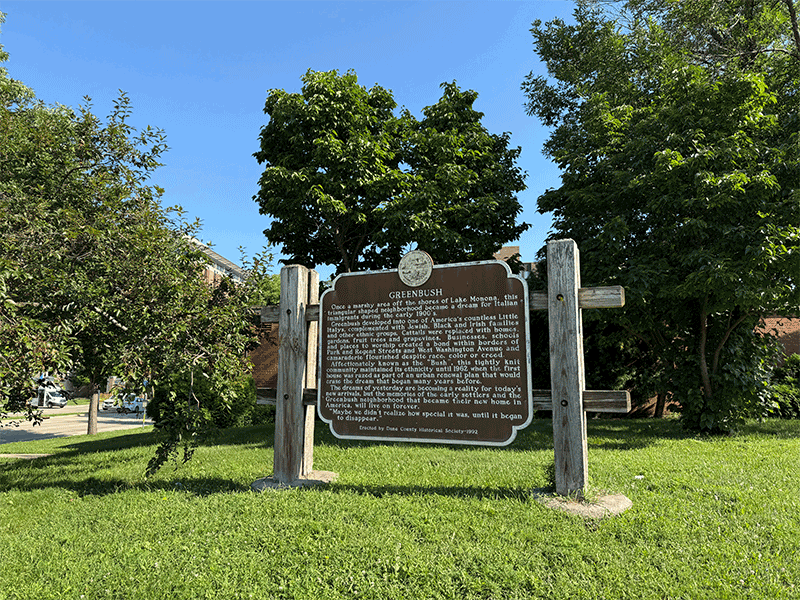 This Wisconsin state historical marker located at the southern tip of the Triangle recounts the history of the Greenbush neighborhood, its immigrant community and its loss to urban renewal.