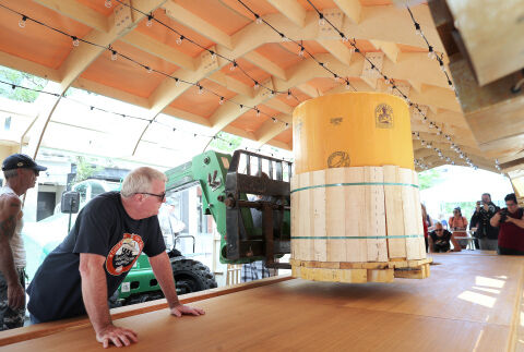 during a Guinness World Records winning attempt at the worlds largest cheeseboard in downtown Madison, Wis., on Wednesday, Aug. 1. The final weight of the cheese on the board came to 4,437 pounds.