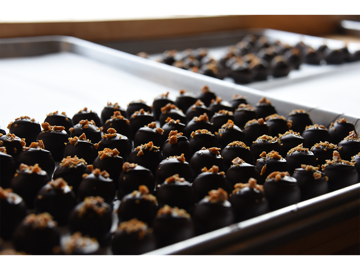 A tray of truffles sits before being placed in the storefront.