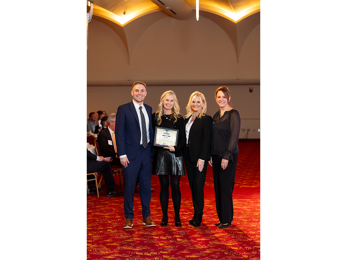 Executive of the Year Anna Stern accepts her award from sponsor reps Matt Vanderloo, Traci Mann and Sherry Herwig.
