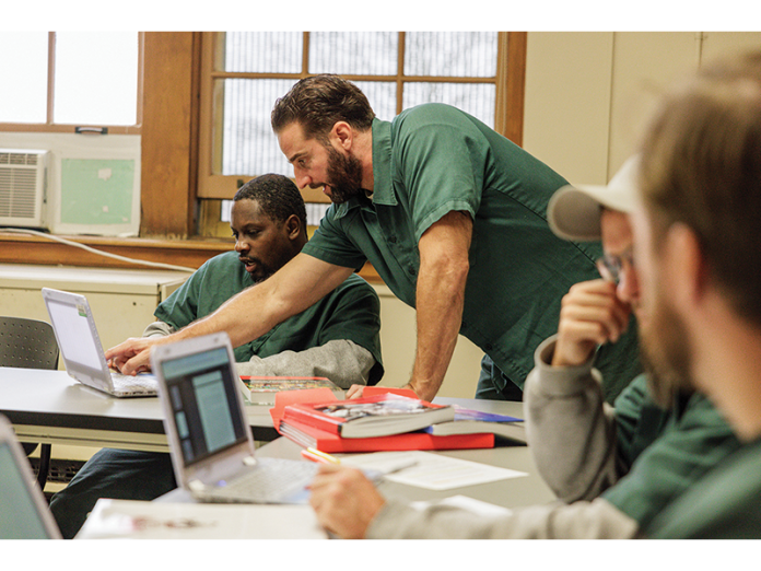 Students Brian Brennan and Joevon Robinson work together on classwork for their UW-Green Bay associate degree program at Oakhill Correctional Institution.