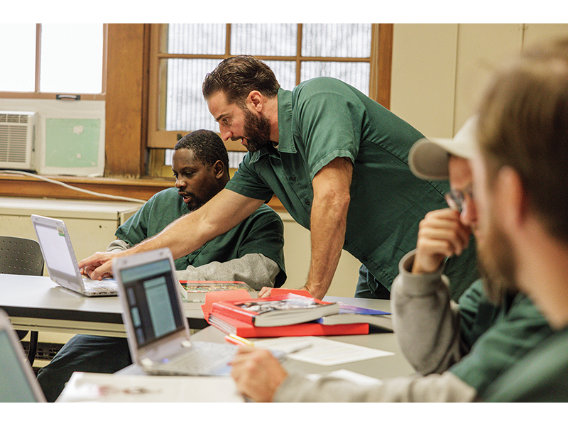 Students Brian Brennan and Joevon Robinson work together on classwork for their UW-Green Bay associate degree program at Oakhill Correctional Institution.