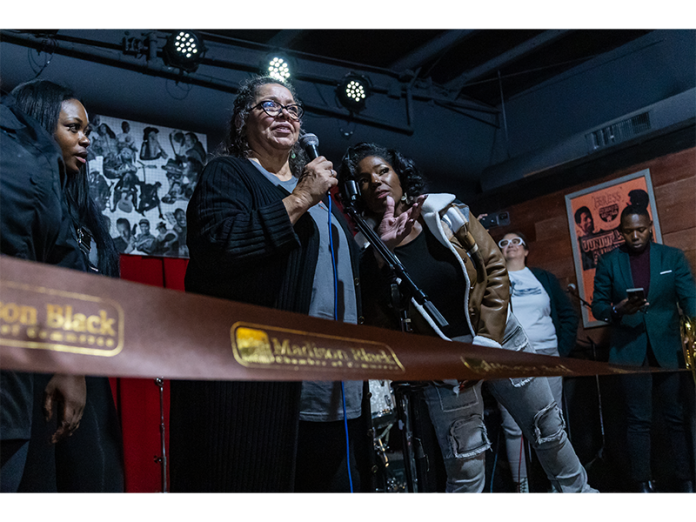 Rita Adair, center, speaks at the grand opening of Bernell's last month.