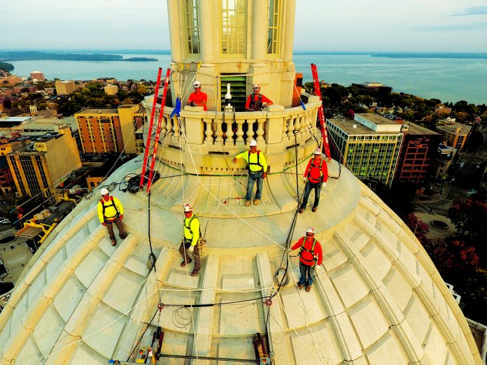 The JP Cullen dome team stands atop the Capitol last summer. Tony Hanus, front row, orange shirt, was the masonry superintendent on the dome project. (Photo by JP Cullen)