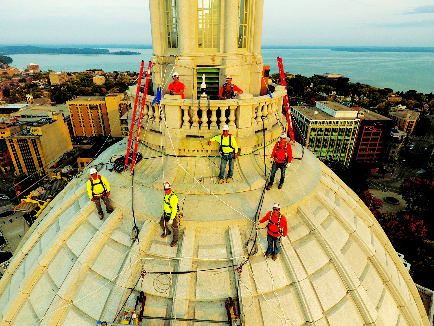 The JP Cullen dome team stands atop the Capitol last summer. Tony Hanus, front row, orange shirt, was the masonry superintendent on the dome project. (Photo by JP Cullen)