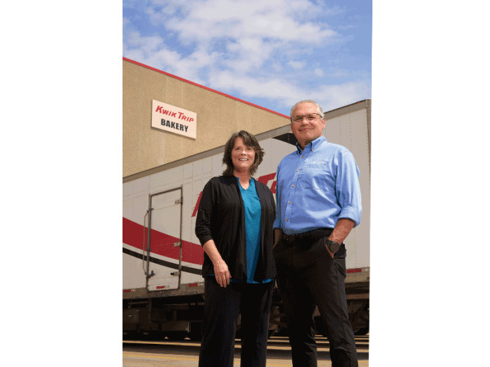 Deb Brazil, convenience transportation recruiter for Kwik Trip, stands with CEO Scott Zietlow in front of one of the many trucks in the company's fleet at its La Crosse headquarters.