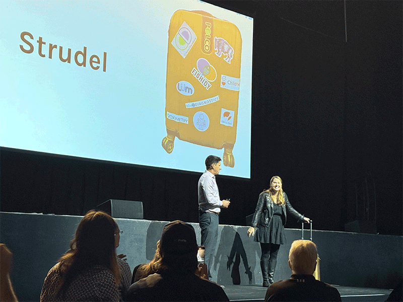 2025 Pressure Chamber pitch competition winner Kristin Isaac, CEO of Strudel, accepts the golden suitcase trophy from Greater Madison Chamber of Commerce vice president Kevin Little at The Sylvee on Tuesday.