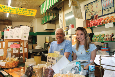 Ken Clary and employee Amber Meisel work the counter at Clary’s Old Fashioned Gourmet Popcorn.