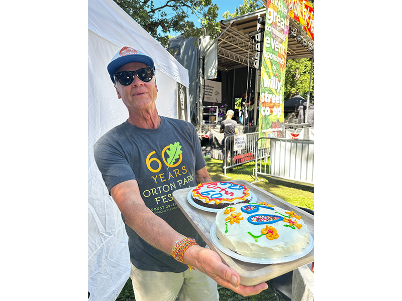 Andy Moore assists with the Who Takes the Cake? event at the Orton Park Festival. Thanks to money raised at its festivals, the Marquette Neighborhood Association awarded nearly $100,000 in grants in 2025 to help community organizations.