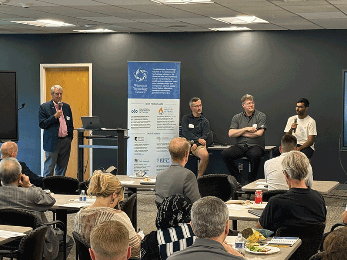 As Wisconsin Technology Council President Tom Still looks on, Remzi Arpaci-Dusseau, the director of UW-Madison's school of Computer, Data & Information Sciences, Google's Milo Martin and Microsoft's Shaleen Deep discuss ties between academia and industry at a Tech Council lunch on Tuesday at One City Schools.