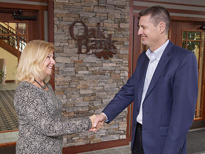 Terry Taylor, Oak Bank president and CEO (right) and a client (left)