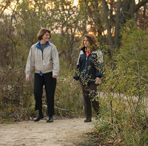 Gundersen Health System employees stroll along the company’s walking trail on its Onalaska campus.