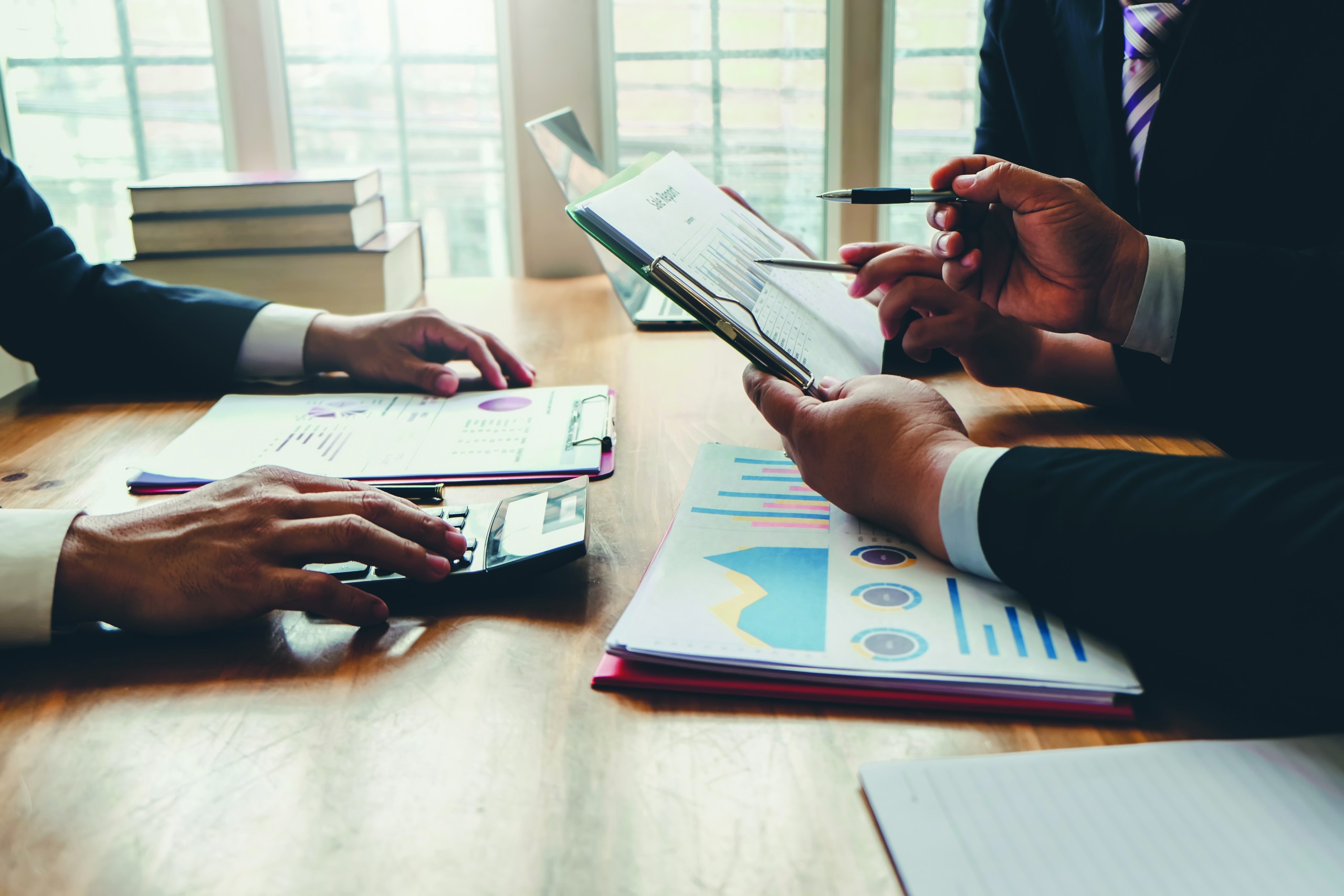 Group Of Business People Meeting Together To Assess Business Pro