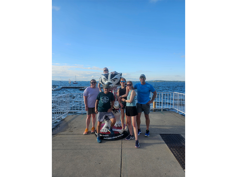 Runners on the weekly Fontana Run take time to pose with the Bucky statue in front of Lake Mendota.