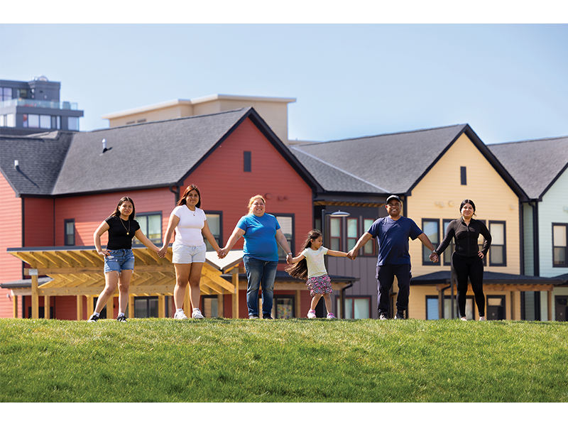 Amelia Corea (center, in blue) and Jose Corea (second from right) said the new Bayview offers a better environment for raising their four daughters.