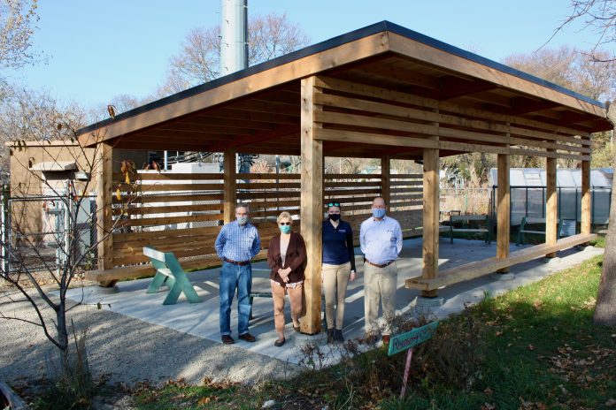 Representatives from Goodman Community Center, EUA, and Vogel Bros. Building Co. stand in the new Founders Outdoor Classroom.