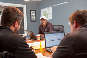 Al Toon, shown in a staff meeting at Olson Toon Landscaping, is one of the founding members of Capitol Bank in Madison and remains on its board of directors. He also serves on the board of National Guardian Life Insurance Co.