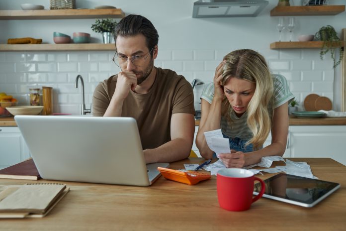 Frustrated young couple going over home finances