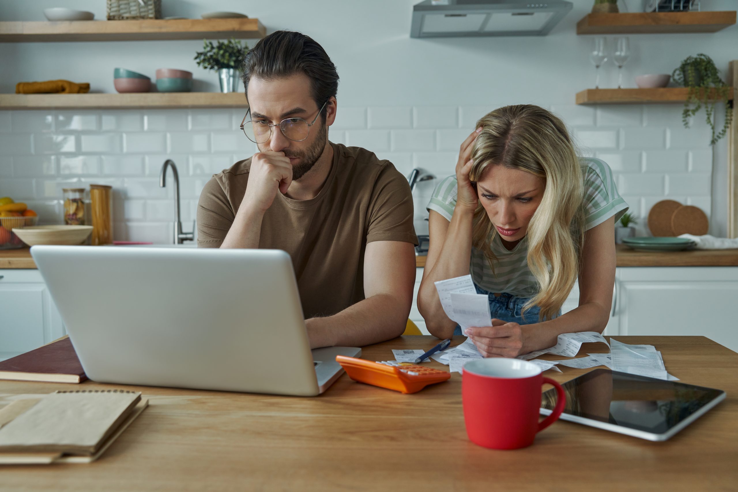 Frustrated young couple going over home finances