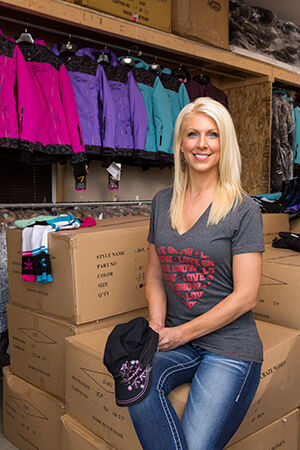 Gearing up for the 2014-15 winter sports season, Wendy Gavinski is surrounded by newly arrived inventory in her Oregon, Wis., warehouse.