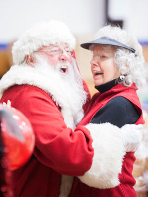 Nice work, if you can get it: At a recent holiday fair at St. Dennis Parish in Madison, Santa Tom Uebersetzig spread good cheer to kids of all ages.