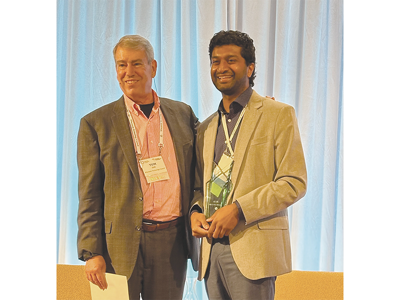 Tom Still (left), now the former president of the Tech Council, which produces the Governor's Business Plan Contest, congratulates Karthikeyan.