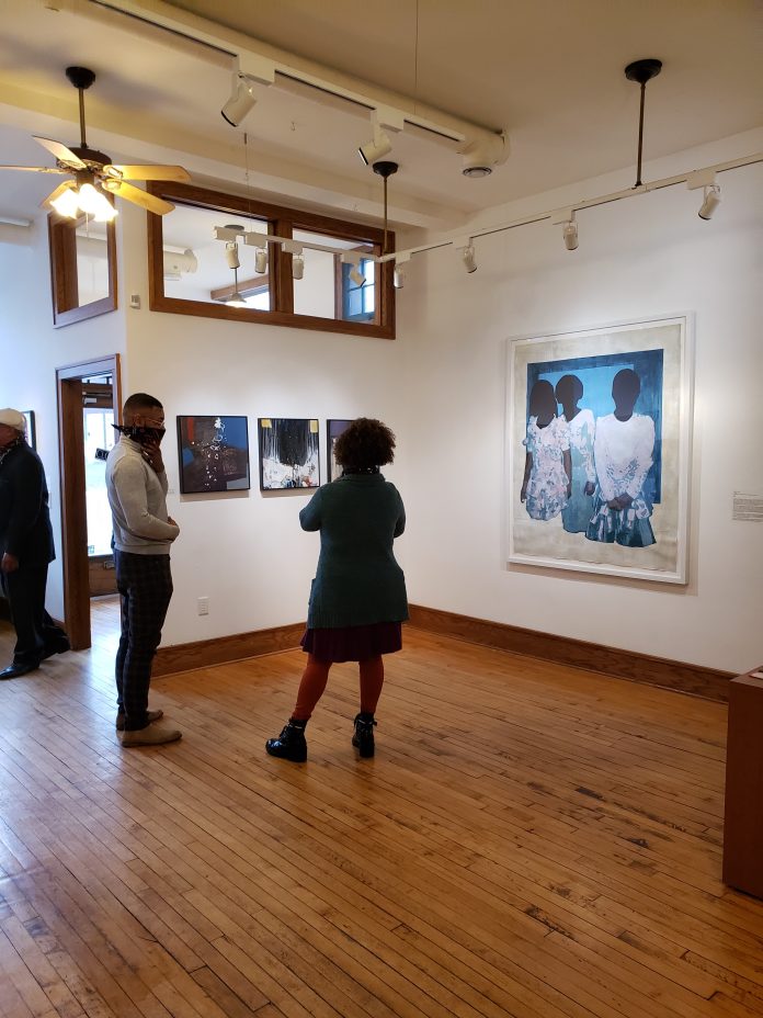 Tony Catteruccia and Carrie Morgan, artwork by Al Johnson, left, and Tyanna Buie