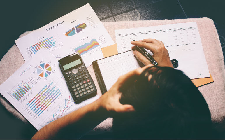 Overhead view of businessman stress in problem with expenses at home office.