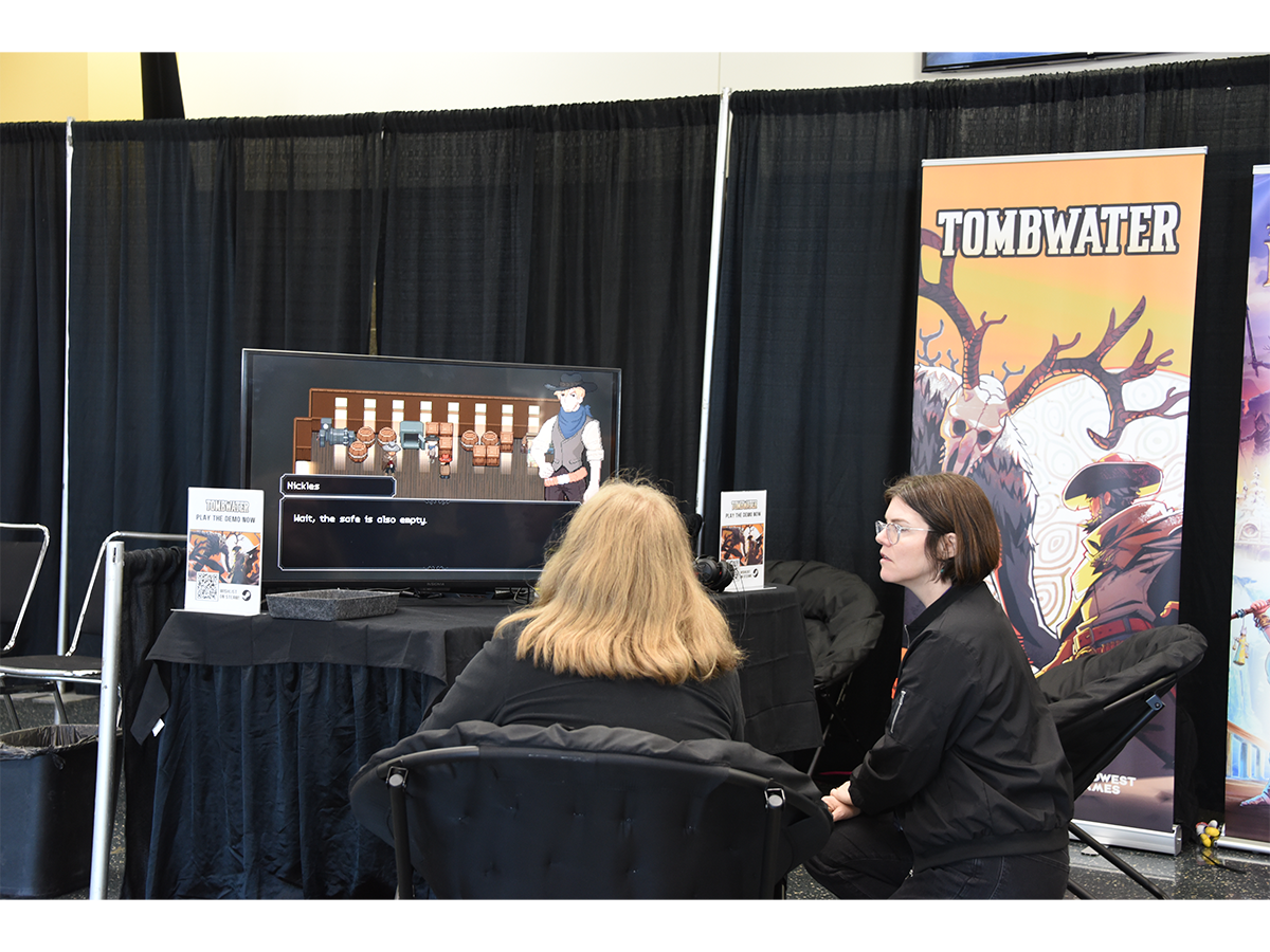 Jen Corbett, chief marketing officer for Midwest Games, demos Tombwater, a game the company plans to publish.