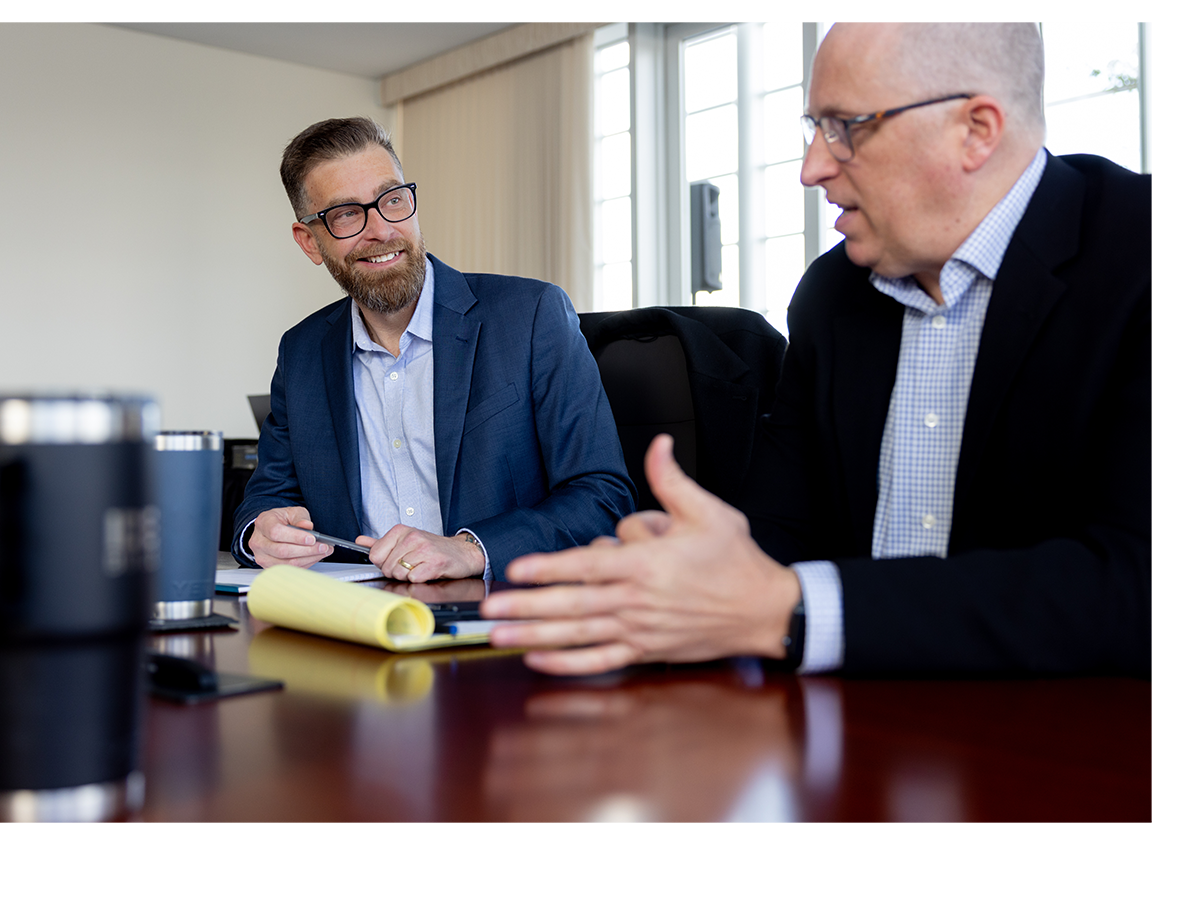Christopher Tatge of DC Materials (left) and Jamie Radabaugh of Boardman Clark engage in a friendly exchange.