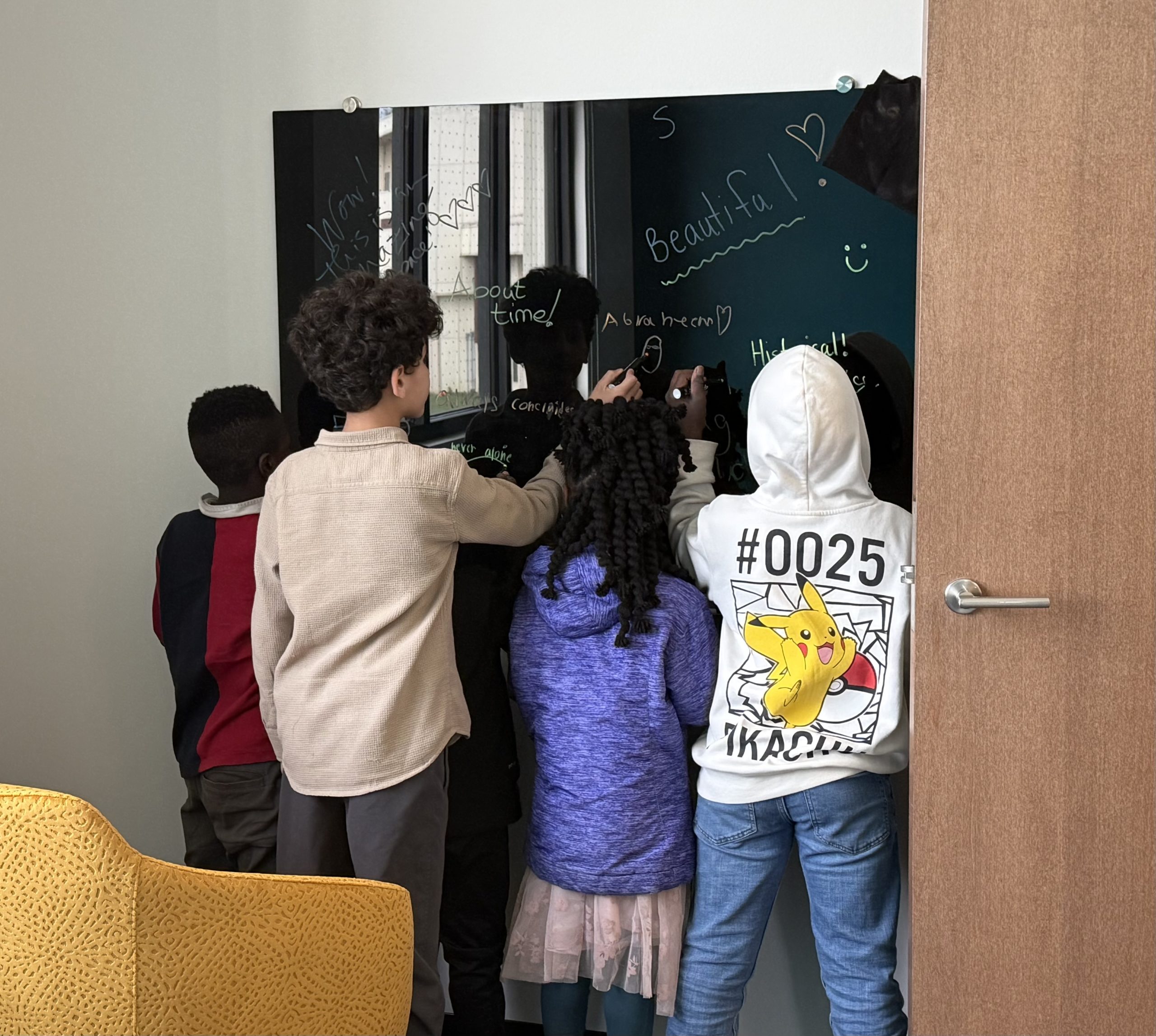 Children expressed their excitement for the Center's opening, writing and drawing on black dry-erase boards throughout the building's youth-centered spaces.