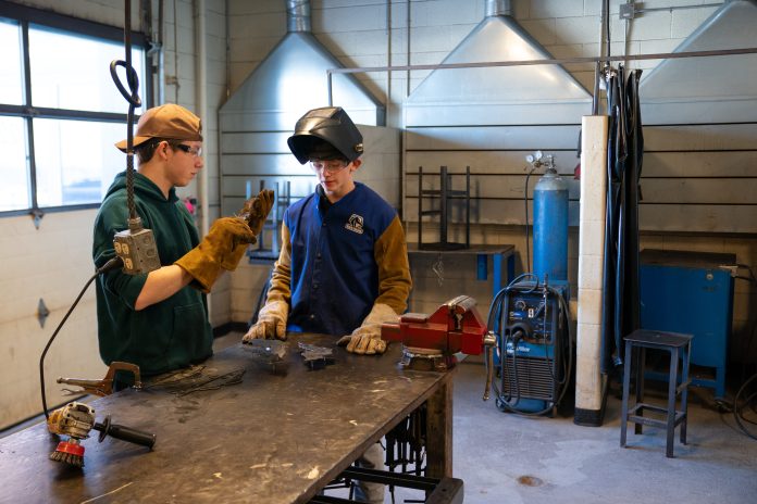 Students work in the shop at Northwestern High School in Maple, Wis., on Feb. 25, 2026. Wisconsin is one of five states that don’t provide funding to public schools for career and technical education programs. (Erica Dischino for Wisconsin Watch)