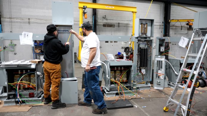Employees at Modular Power & Data work on modular power systems in Cudahy, Wis., Feb. 25, 2026. (Trisha Young / Wisconsin Watch)