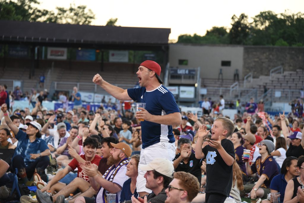 People cheering for the USMNT at Breese Stevens Field on June 12.