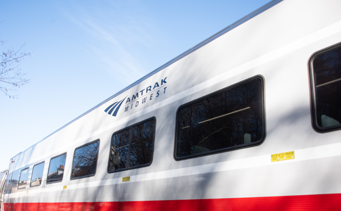 Side of white and red Amtrak train.