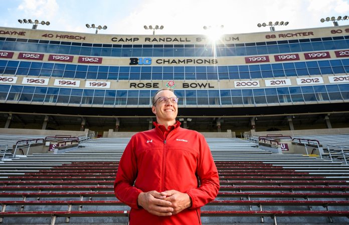 Chris McIntosh, soon-to-be director of UW Athletics, stands in Camp Randall Stadium at the University of Wisconsin-Madison on June 1, 2021. In the background is reference to the Wisconsin football team’s participation in the 1999 and 2000 Rose Bowl games, championship-wins that McIntosh played in as an offensive tackle for the Wisconsin Badgers. McIntosh, UW’s deputy athletic director since in July 2017, will formally become director of UW Athletics on July 1, 2021. (Photo by Jeff Miller / UW-Madison)