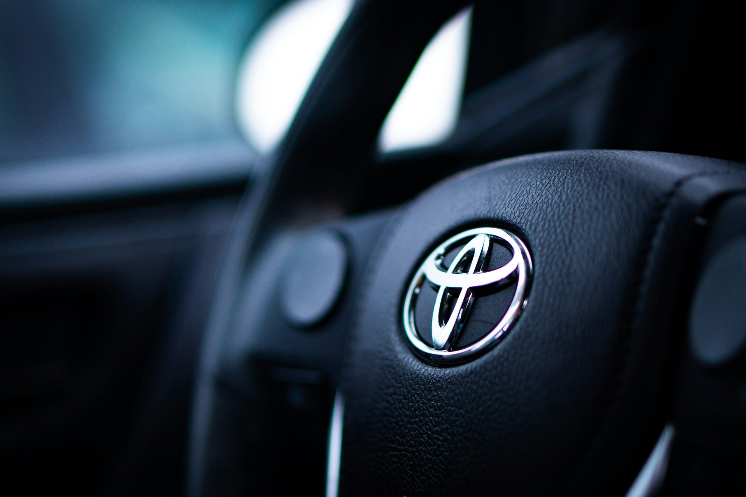 A Toyota car steering wheel with Toyota logo