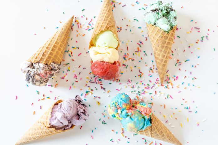 Five ice cream cones on a table