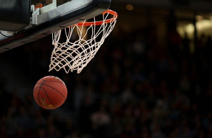 A basketball that has just fallen through a hoop