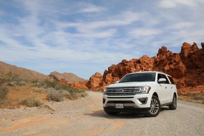 A white vehicle in a desert setting