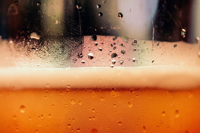 A closeup of amber-colored beer in a glass.