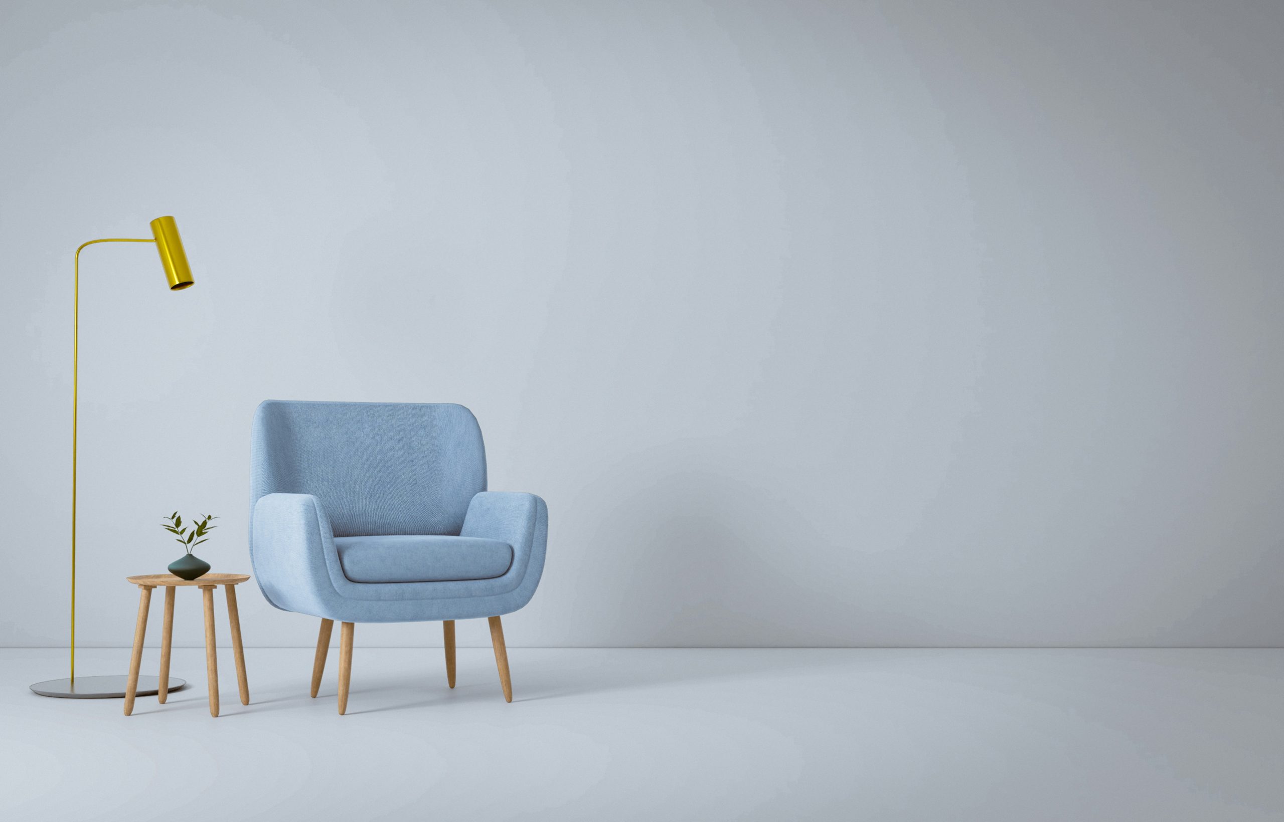 Yellow lamp next to a blue chair and tiny side table.
