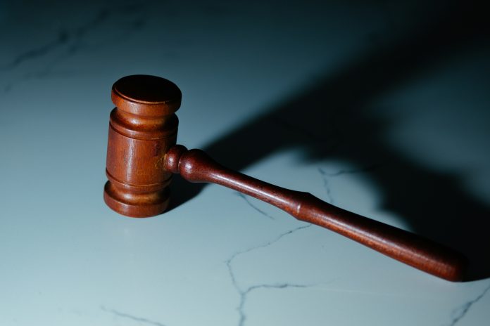 A gavel rests on a table.