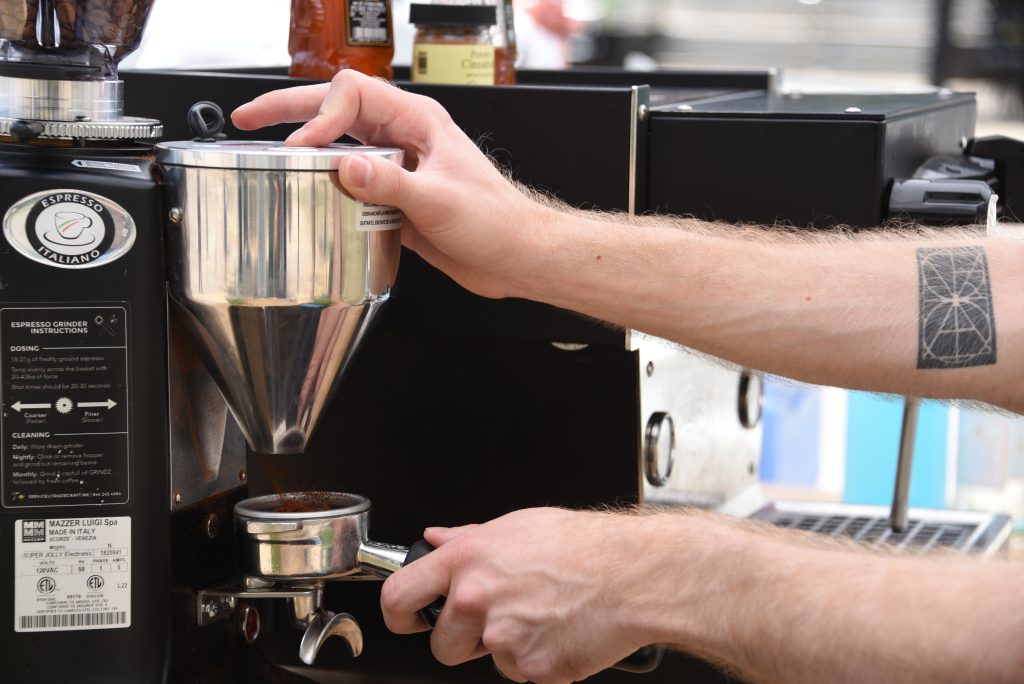 A man grinding coffee