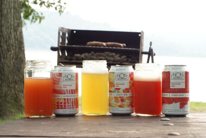 Three NA beers on a picnic table