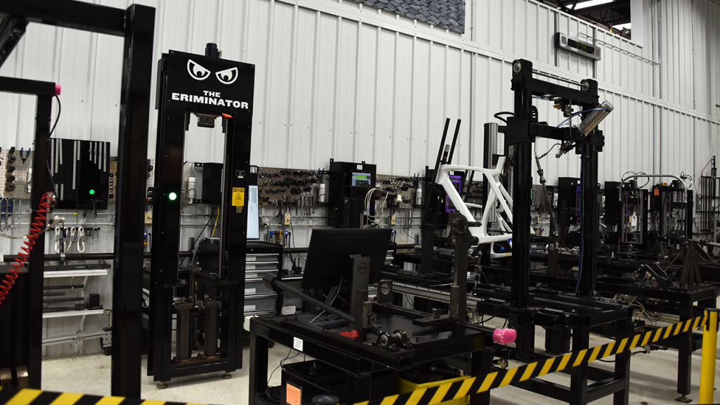 A room full of black machines used to stress test bikes and components