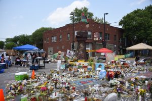 A memorial full of art, candles and more, with a giant fist in the middle acting as a memorial to Corey Ruiz, who was fatally shot by a police officer